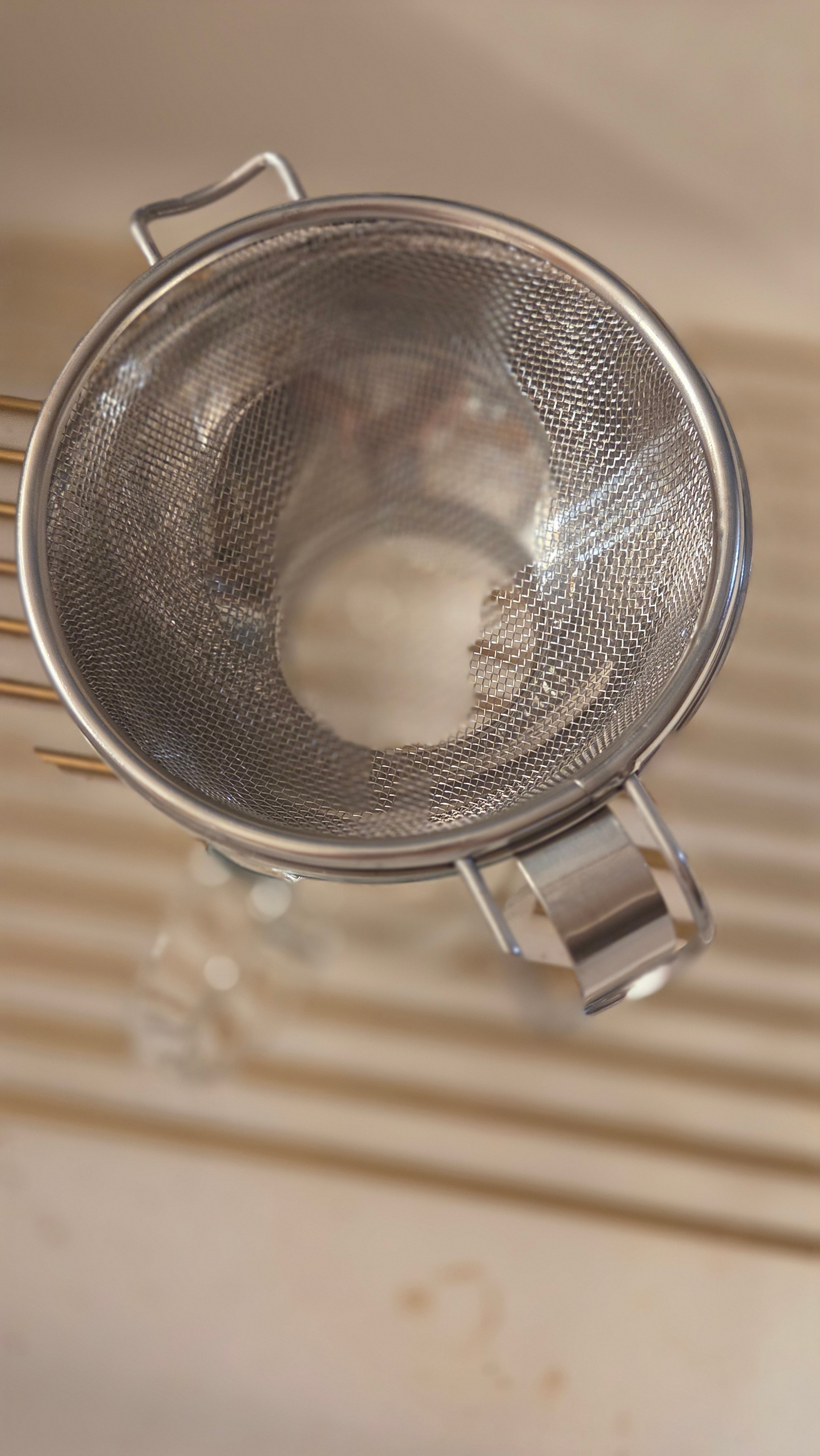 Fine mesh strainer ready to strain the butter and buttermilk