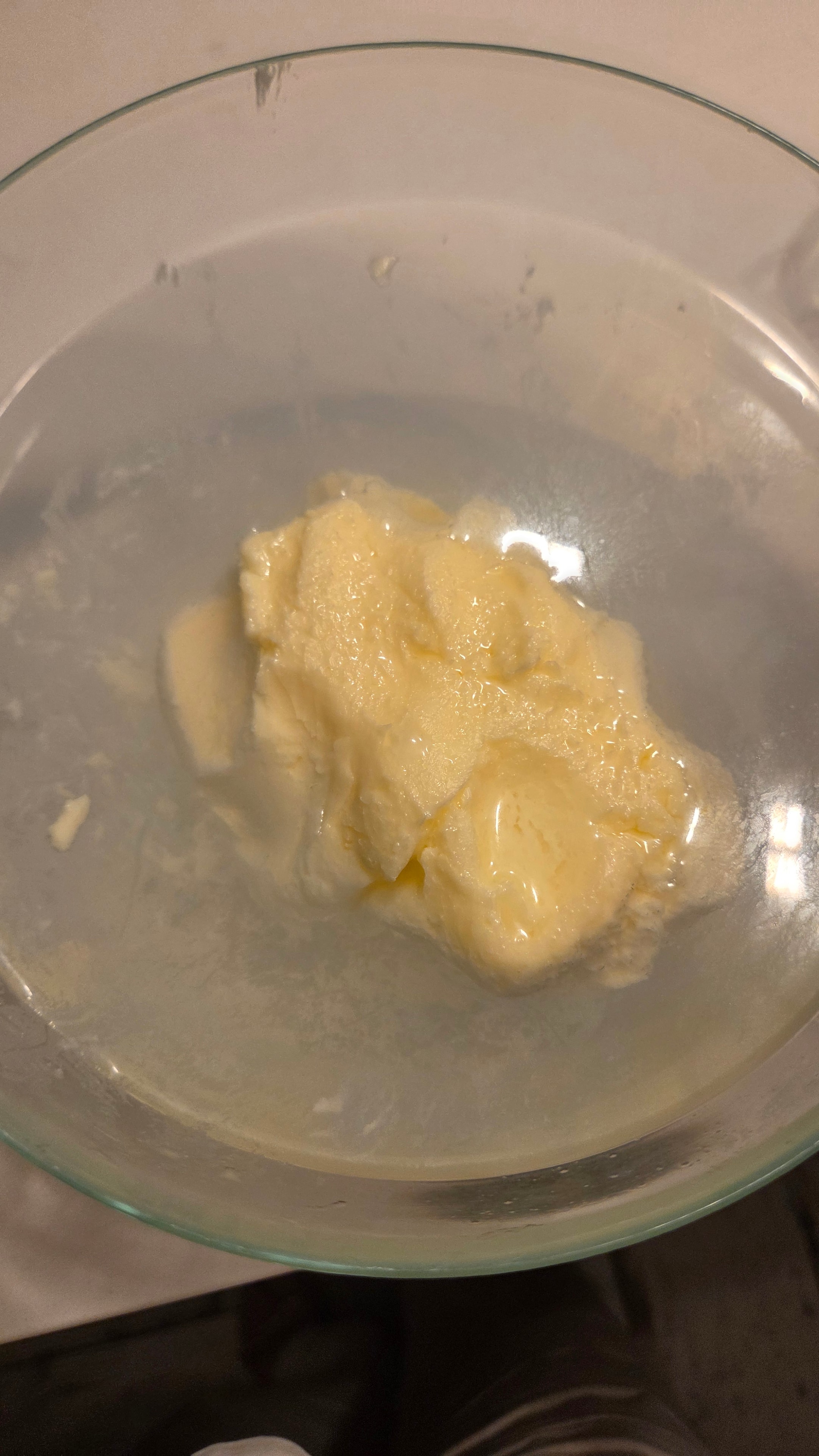 Fresh butter rinsed in a glass bowl with cold water