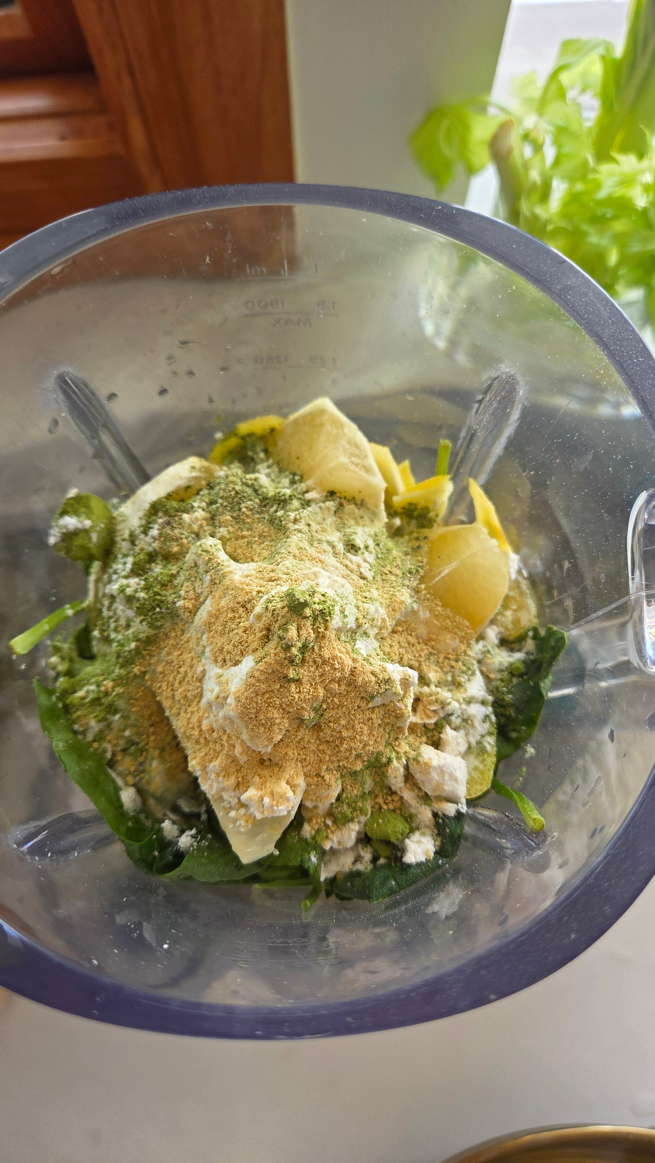 Spinach, lemon, lime, banana, matcha, protein and creatine loaded into the blender