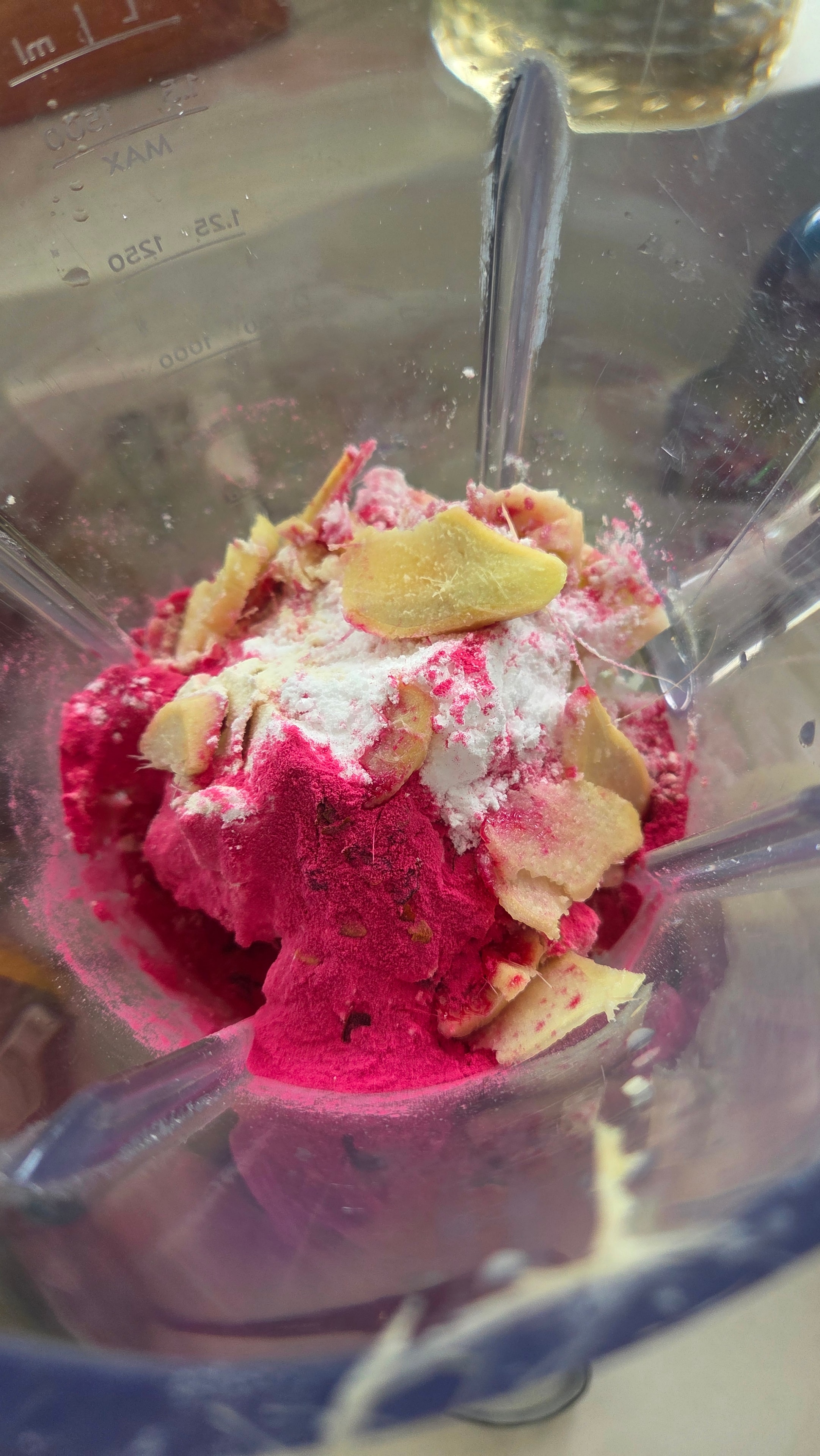 Whey protein and creatine added to the blender alongside the pitaya powder