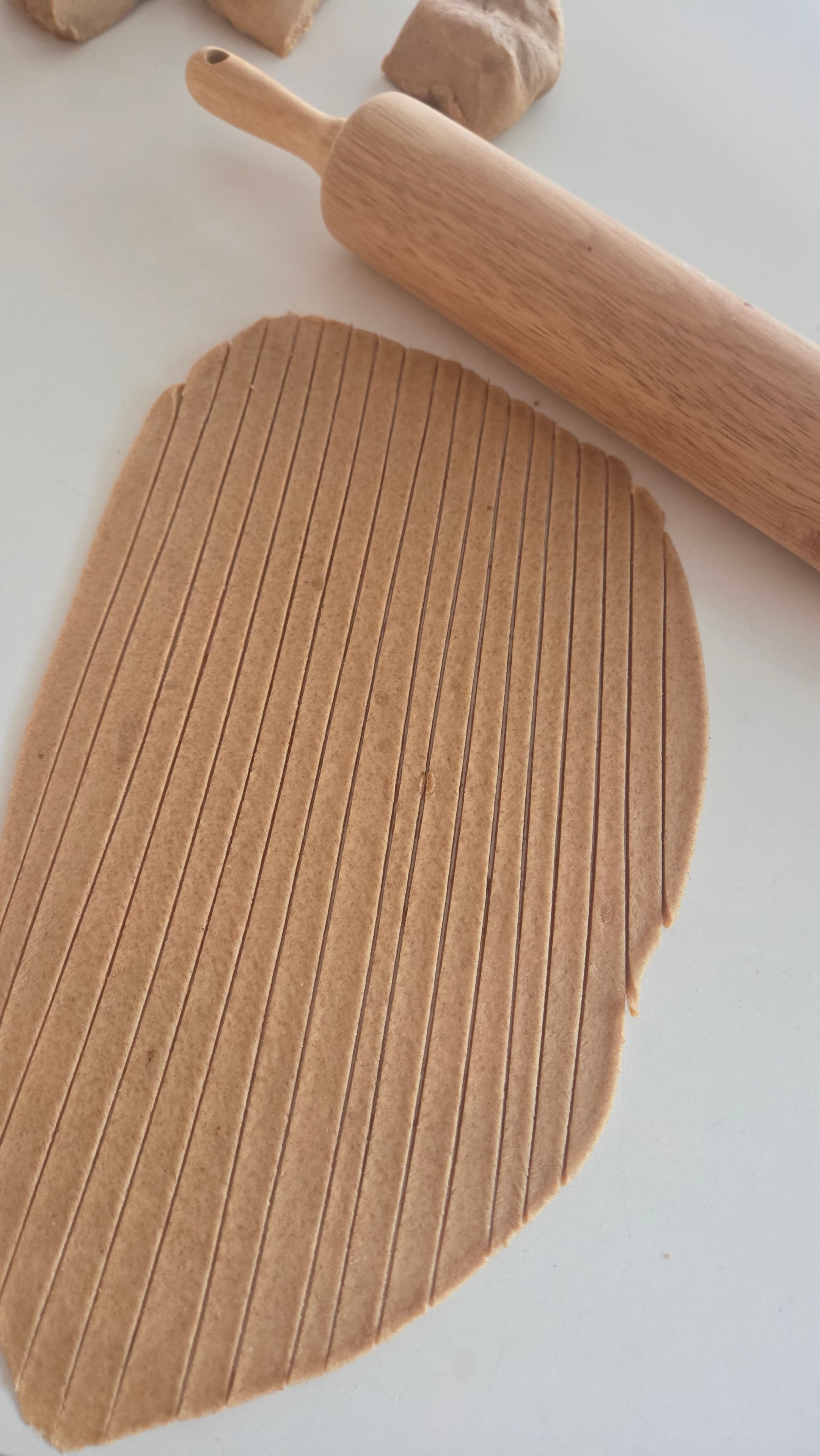 Hand-rolled whole wheat pasta dough cut into tagliatelle ribbons